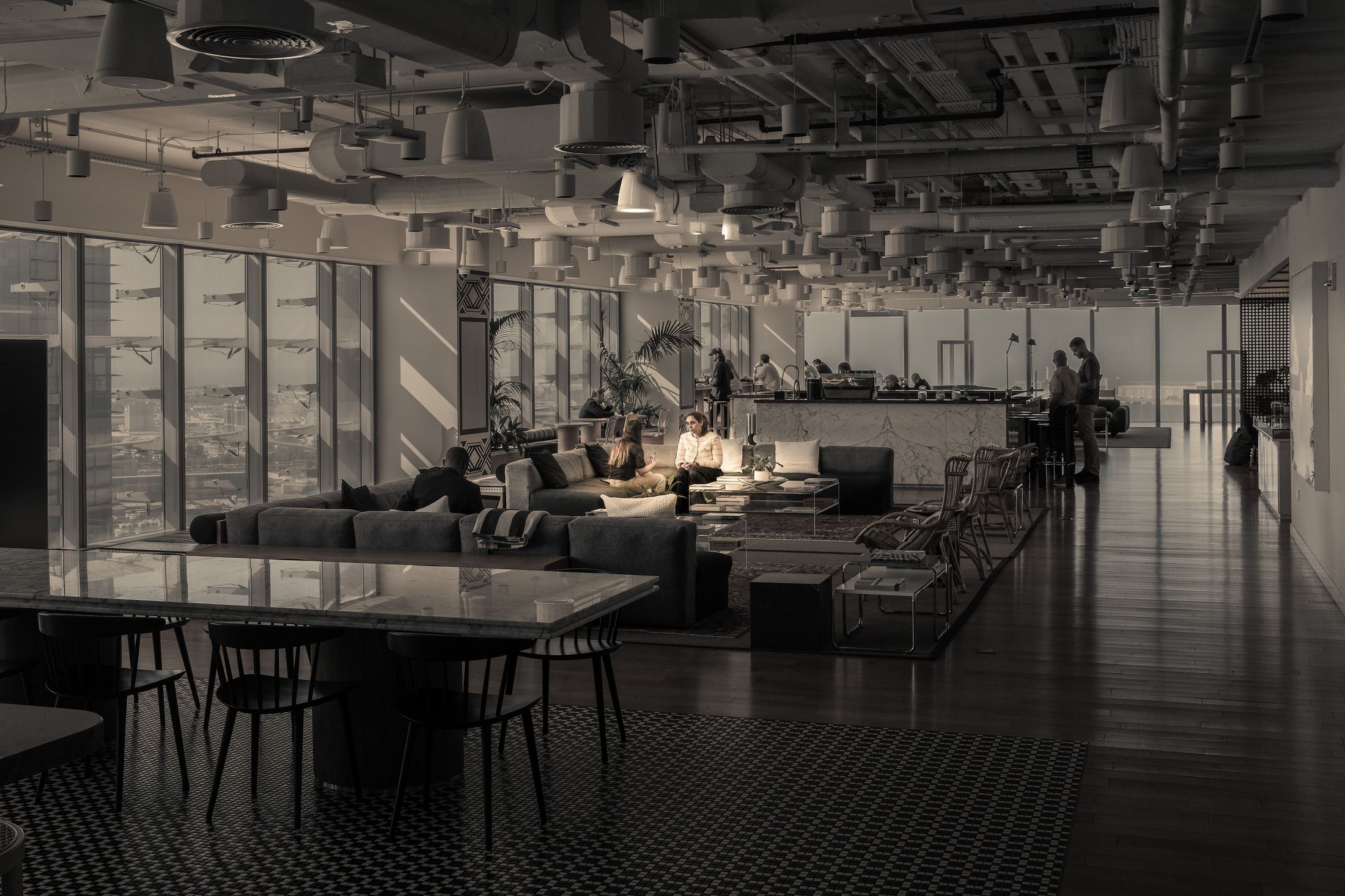 A workplace at low light, a floor plan drawn across it